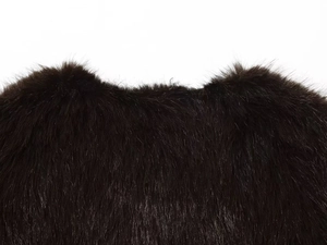 Close-up of fluffy dark brown faux fur texture on a cropped sleeveless vest