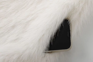 Close-up of white faux fur vest fabric texture with modern minimalist style