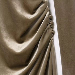 Elegant dark brown velvet dress with shoulder pads and sophisticated ruching details