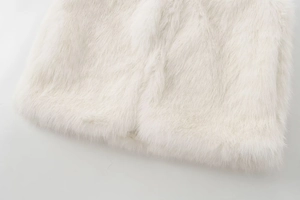 Close-up detail of soft white faux fur texture on a stylish autumn winter vest