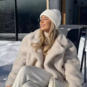 Chic cream-white oversized faux fur teddy coat with wide lapels for winter warmth