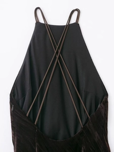 Detail of cross back straps and invisible zipper on dark brown velvet dress