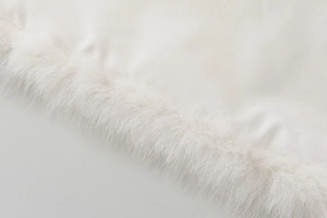 Detailed close-up showing white faux fur trim and elegant satin fabric texture