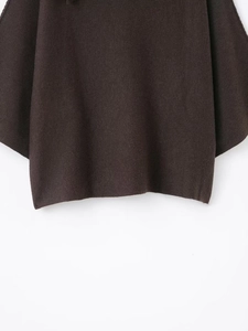 Detail of soft dark brown knit texture and hem on a stylish women's sweater set