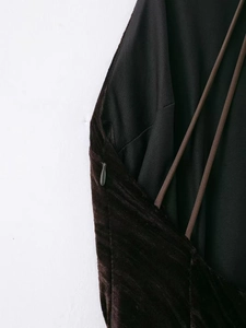 Close-up of brown velvet dress showing side invisible zipper and delicate straps