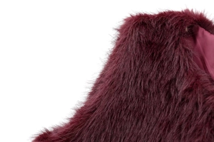Close-up of burgundy faux fur vest featuring long-pile texture and smooth satin lining