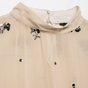 Sheer apricot high-neck blouse with silver sequins and pearl button closure detail