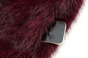Detail showing high-density burgundy faux fur texture and a functional hidden side pocket