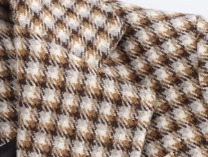Macro view of plaid pattern fabric with gold metallic thread for women long coat