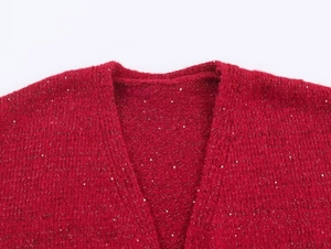 Close-up of red V-neck knit cardigan with subtle silver sequins and chunky texture
