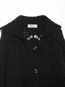 Detail shot of the large collar and knit texture on this black button-up cardigan