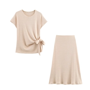 Close-up of beige knit two-piece set featuring side-tie knot detail and size S label
