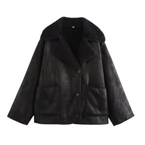Detail of a black shearling jacket with large lapels and textured faux suede finish