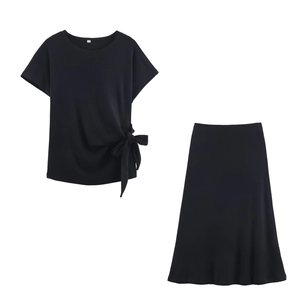 Detailed view of the soft black knit midi skirt with an elegant side knot and A-line cut