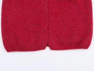 Detail of red knit cardigan fabric with sparkling sequins and fuzzy mohair texture