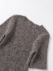 Close-up of crew neck and shoulder detail on grey melange textured knit top with fringe