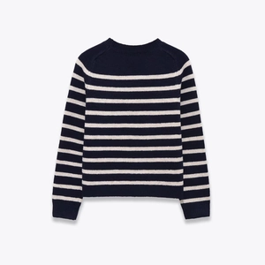 Detail of classic navy and off-white striped knit sweater with ribbed cuffs and hem