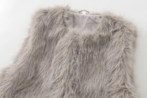 Close-up of fluffy faux fur vest in grey with V-neckline and smooth fabric lining
