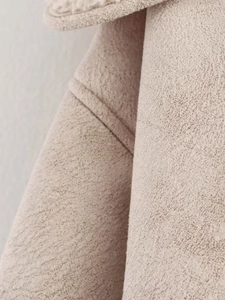 Macro detail of beige faux suede fabric and shearling lining on fashion jacket