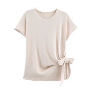 Close-up of beige ribbed knit top with a knot tie detail and soft texture