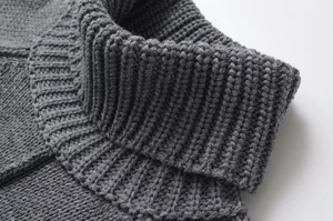 Detailed macro view of dark grey thick rib-knit turtleneck texture on a cozy winter sweater