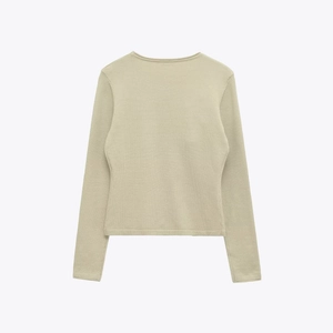 Slim fit long sleeve knit sweater for women in sage green color shown from the back view