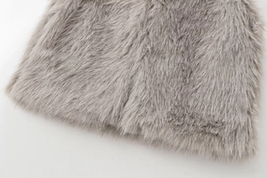Detail view showing the soft texture and thick fibers of the gray faux fur vest fabric