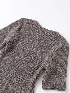 Close-up of knit fabric texture on short-sleeve top with brown and white mixed yarns