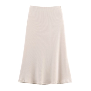 Detail of beige A-line midi skirt showing the soft vertical ribbed texture and minimalist cut