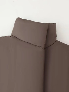 Close-up of the stand-up collar and smooth brown fabric on the padded winter jacket