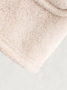 Macro view showing the plush texture and neat stitching of the beige fleece jacket