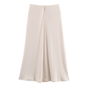 Detail view of the beige ribbed midi skirt showing soft fabric texture and front pleats