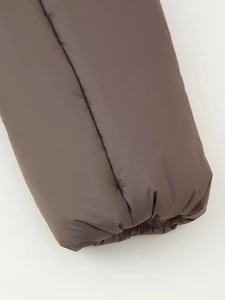 Detail of dark brown windproof jacket cuff with elastic hem for winter warmth