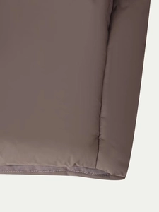 Detailed close-up of quilted coffee-colored winter jacket with matte synthetic fabric