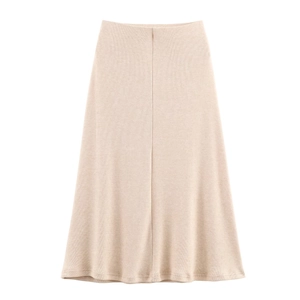 Close-up of beige rib-knit midi skirt showing soft texture and A-line cut details