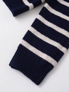 Macro shot of navy and cream striped knit fabric with detailed ribbed cuff texture