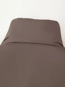 Close-up of smooth dark chocolate brown fabric with subtle silky sheen and texture