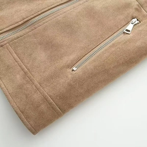 Detailed view of brown suede biker jacket with silver zipper and refined stitching