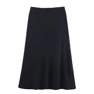 Detail of a black midi A-line skirt featuring a smooth center seam and elegant drape
