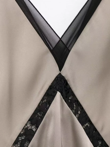 Gros plan détaillé du décolleté en V avec dentelle noire sur une robe en satin kaki