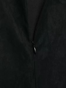 Detailed macro view of the invisible zipper and matte suede texture on the black mini dress