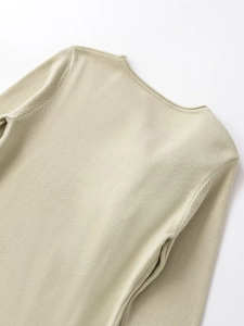 Detailed view of the shoulder seam and round neckline of a slim knit floral sweater