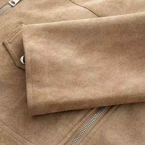 Detail view of khaki suede jacket showing smooth zipper and silver snap button pocket