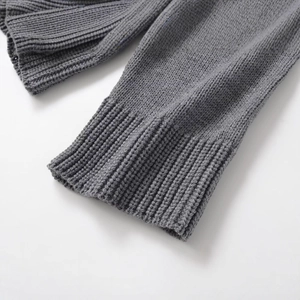 Women's gray knit sweater featuring a ribbed cuff and high-quality minimalist texture