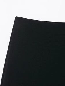 Detailed macro view of high-density black woven fabric texture and refined waist stitching