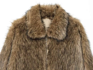 Detailed view of brown faux fur jacket featuring large lapels and a sturdy metal zipper