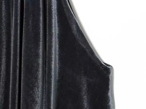 Macro shot of dark grey velvet fabric with elegant folds and glossy texture for top