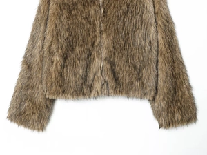 Detail of brown faux fur jacket showing thick texture and central metal zipper closure