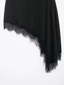 Detail showing asymmetric hem with black eyelash lace trim on satin skirt fabric