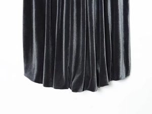 Detailed macro view showing the plush velvet texture and pleated drape of the black velvet top